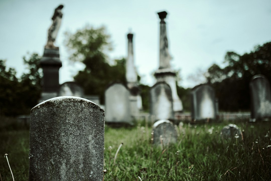Weathered old gravestones leaning in an early American cemetery