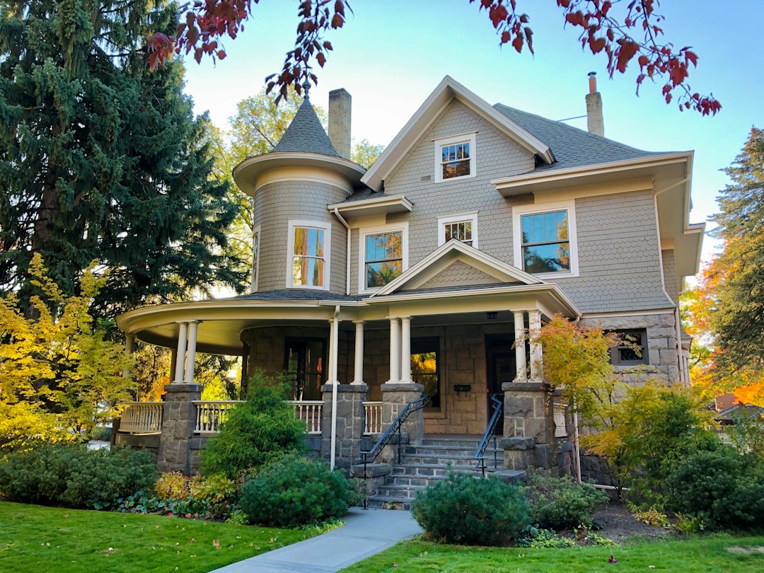Victorian mansion with turret among fall trees