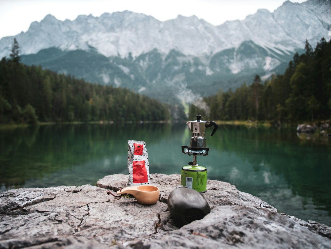 Steaming coffee poured from a thermos at a cold morning camp