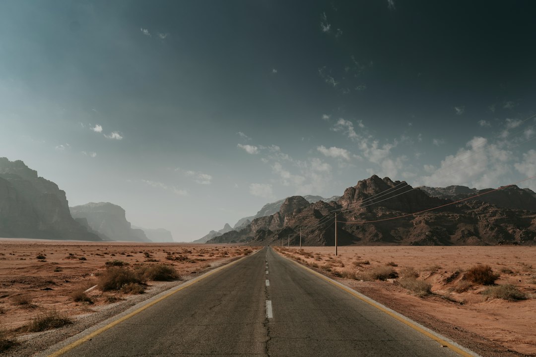A dirt road winding through desert mountains toward ghost town country