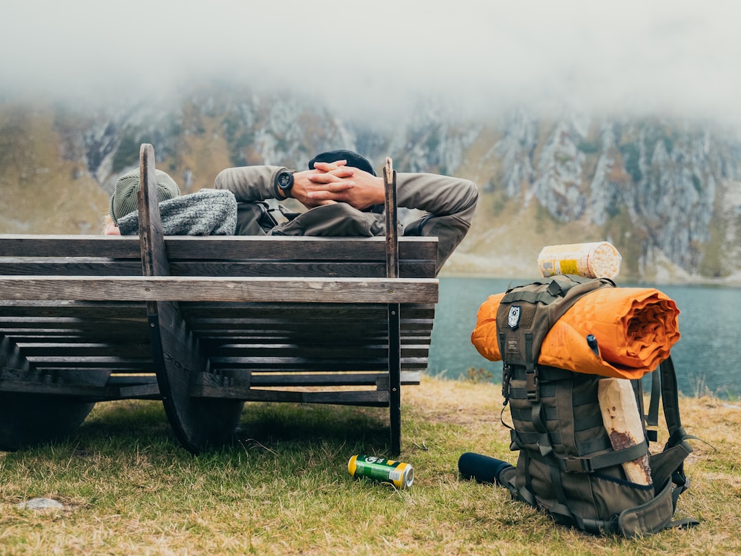 Puffy packable camping blanket rolled on a backpack