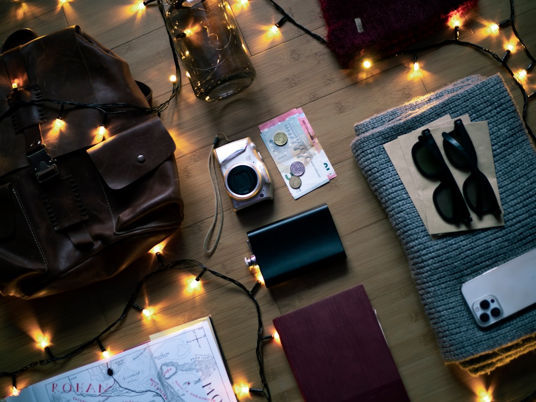 Flat lay of travel gear including flashlights and camera equipment