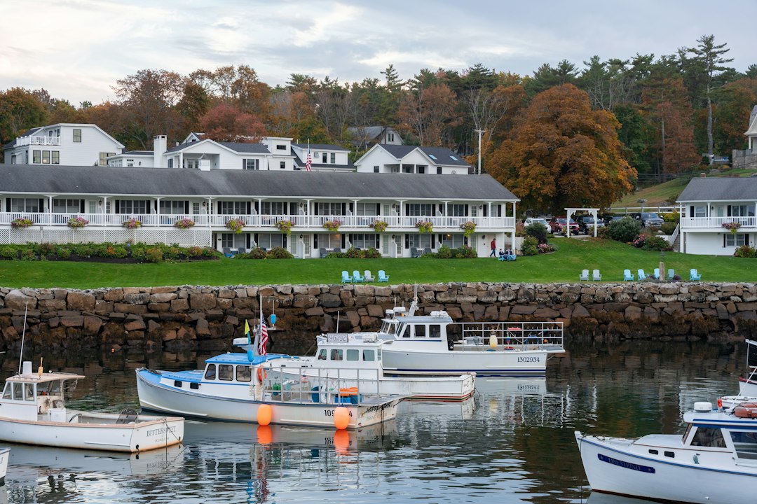 Boats moored in a small New England harbor town at dusk