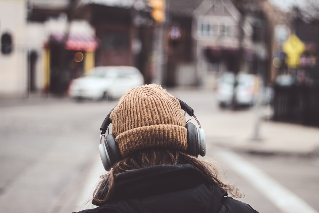 Traveler wearing over-ear headphones on a trip