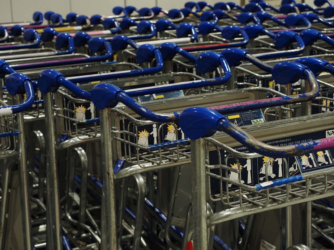 Rows of luggage carts lined up outside an airport terminal
