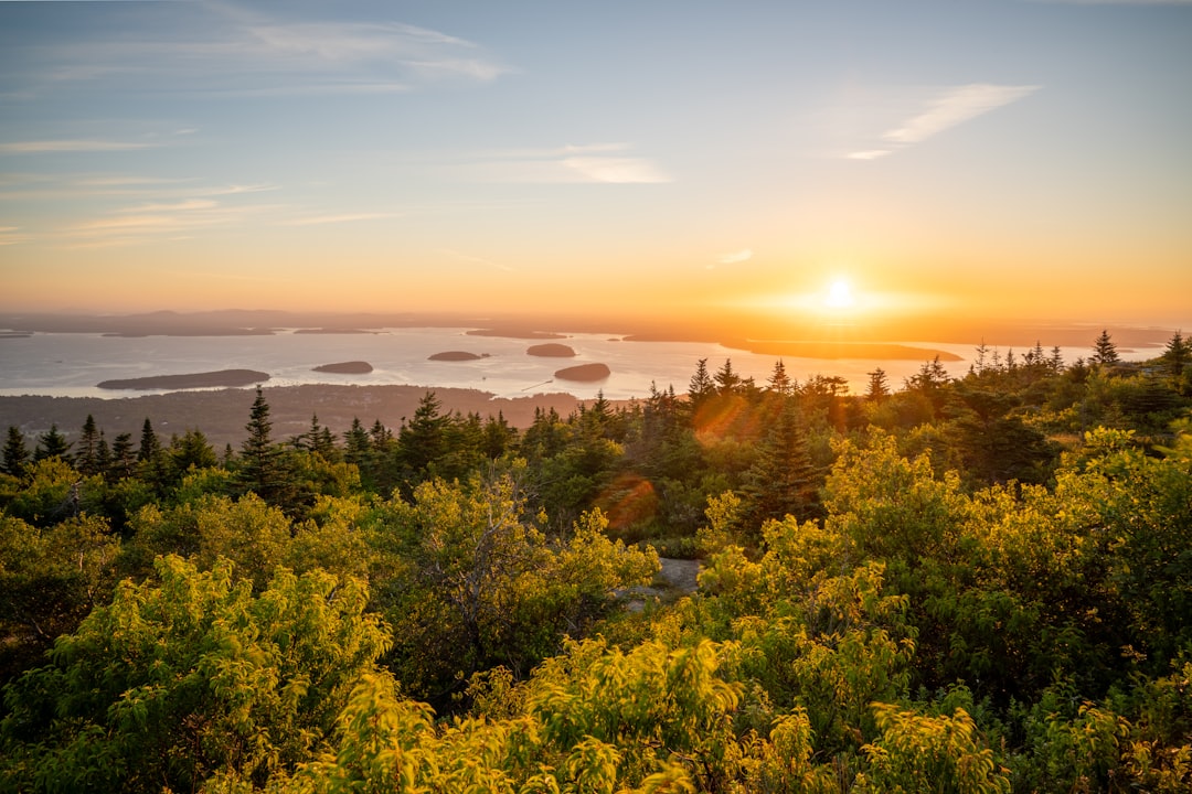 First light breaking over islands as seen from a mountain summit at dawn