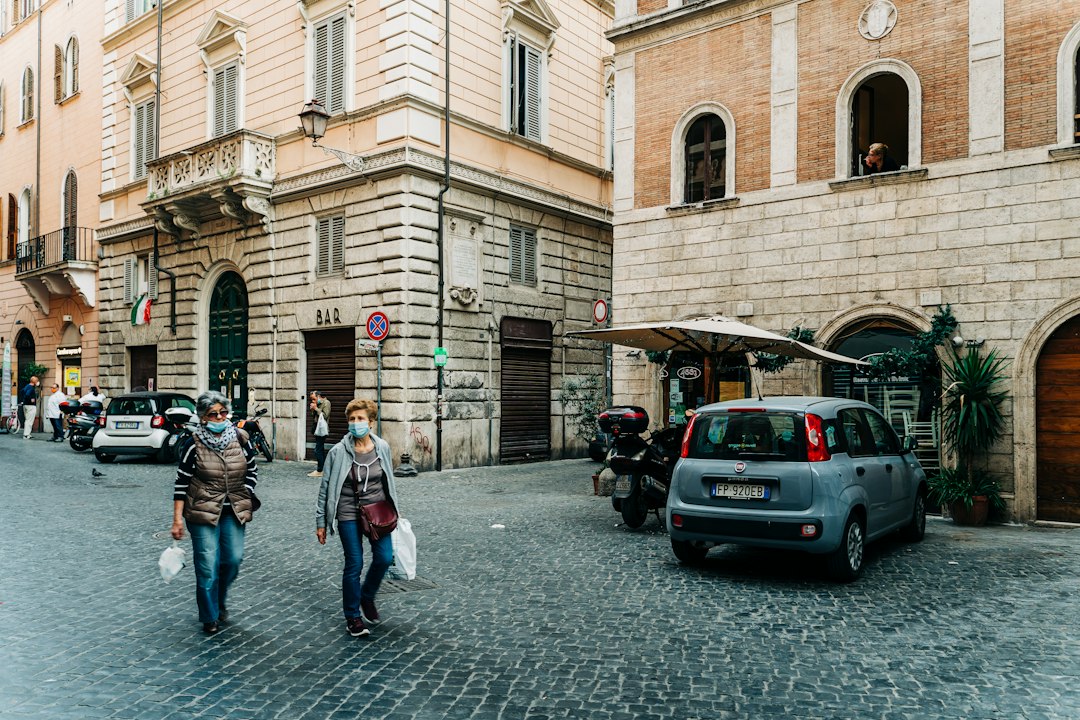 Historic cobblestone street lined with shops in a fall town