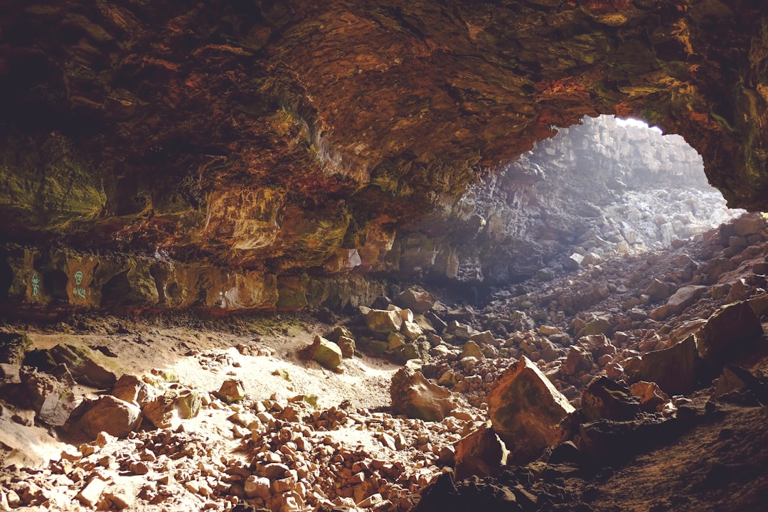 Sunlight shafting into a large rock shelter recess