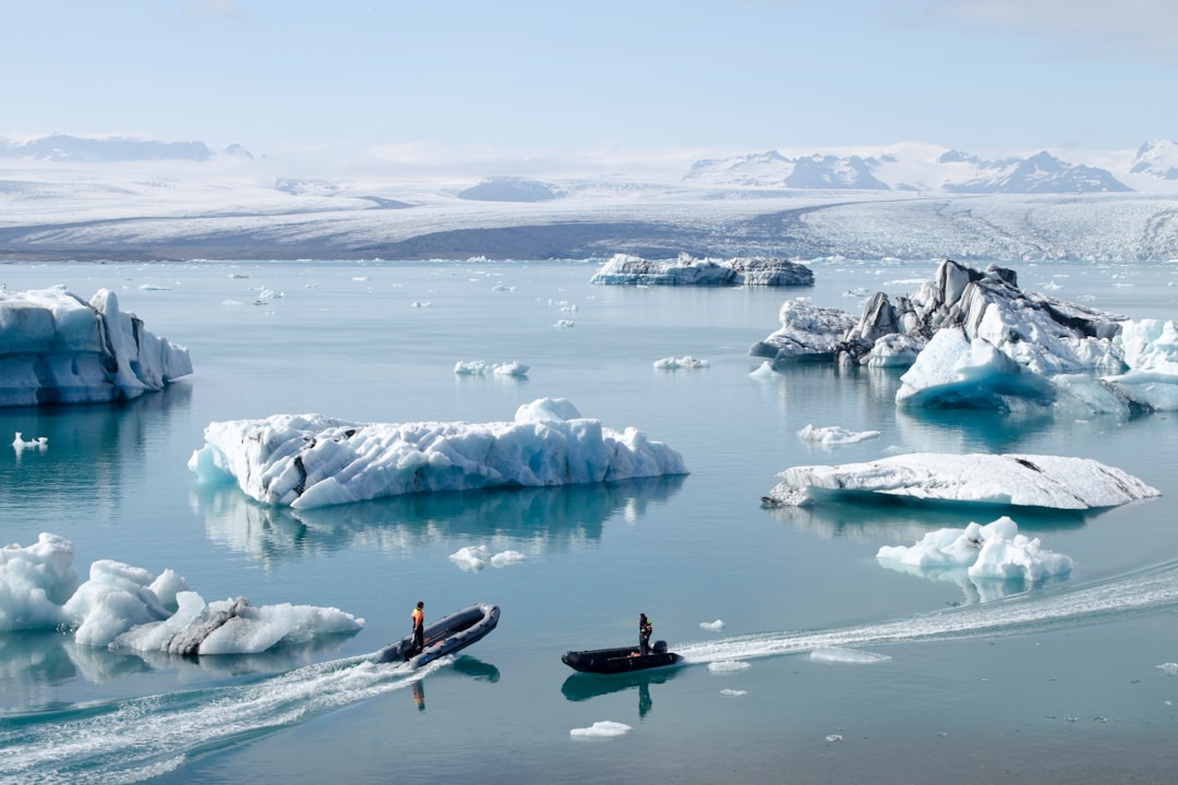 Kayaker paddling among icebergs on a glacial lake