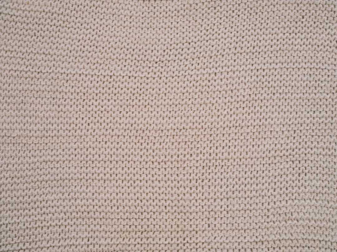 Close-up of woven wool blanket texture in warm tones
