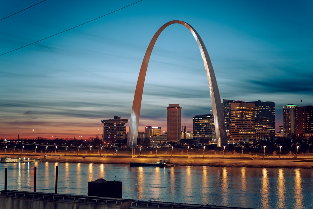 Gateway Arch and St. Louis skyline at twilight across the Mississippi River