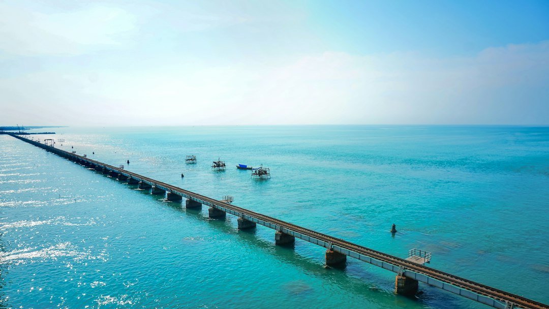 Boardwalk and pier over calm turquoise water at a Florida beach