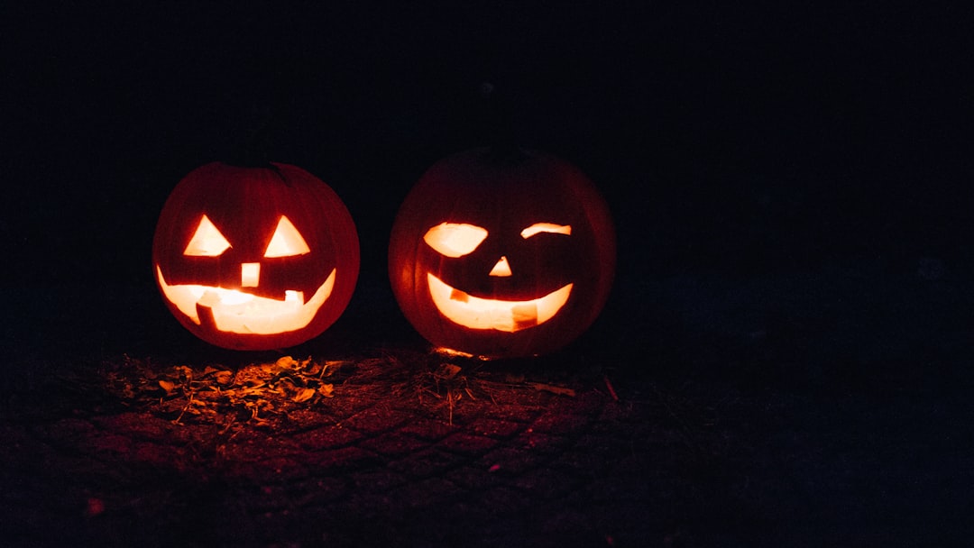 Glowing carved jack-o-lanterns displayed at night