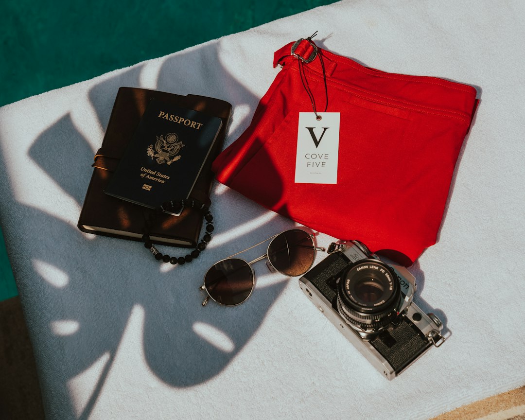 Flat lay of passport and travel documents with accessories