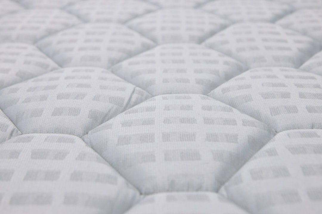 Close-up of a quilted white mattress surface