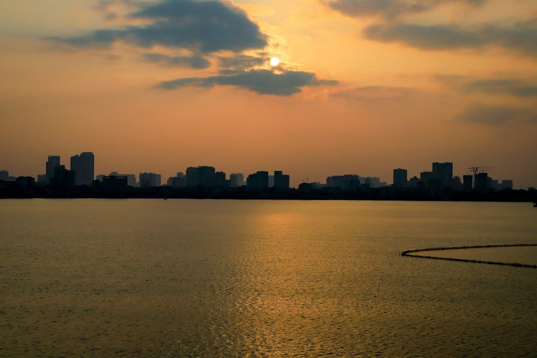 Downtown Milwaukee skyline glowing across the lake at sunset