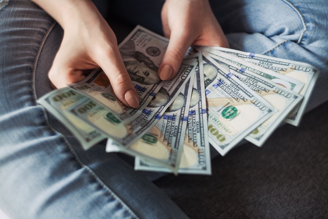 Hands counting US banknotes