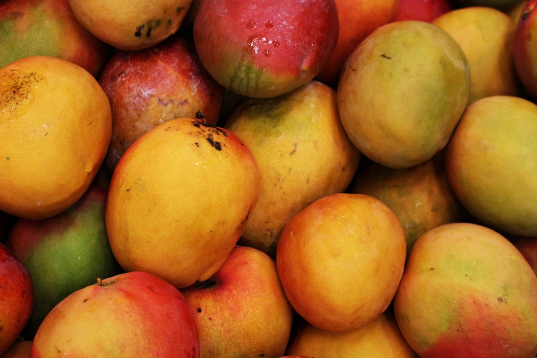 A pile of ripe mangoes at a fruit market