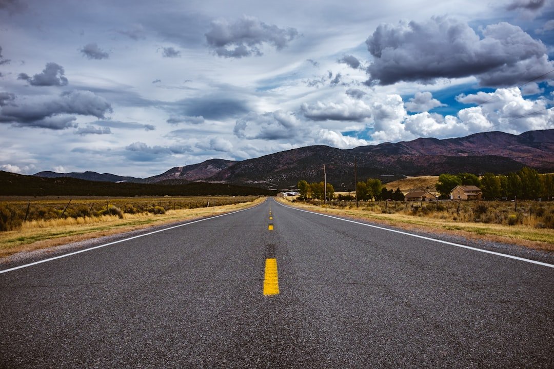 Two-lane rural highway stretching toward the horizon