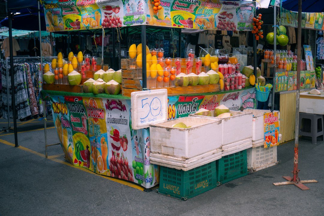 Tropical fruit stall with mangoes and coconuts