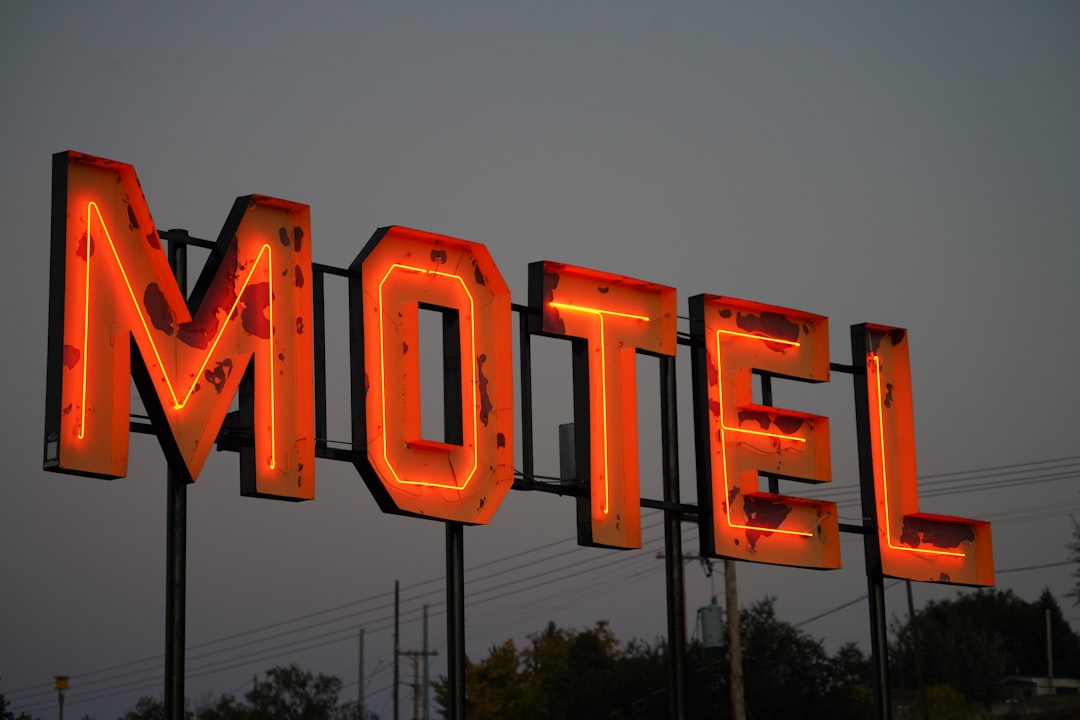 Vintage red neon motel sign glowing at dusk