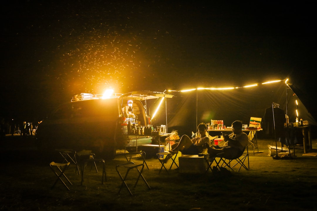 String lights glowing over a campsite at night