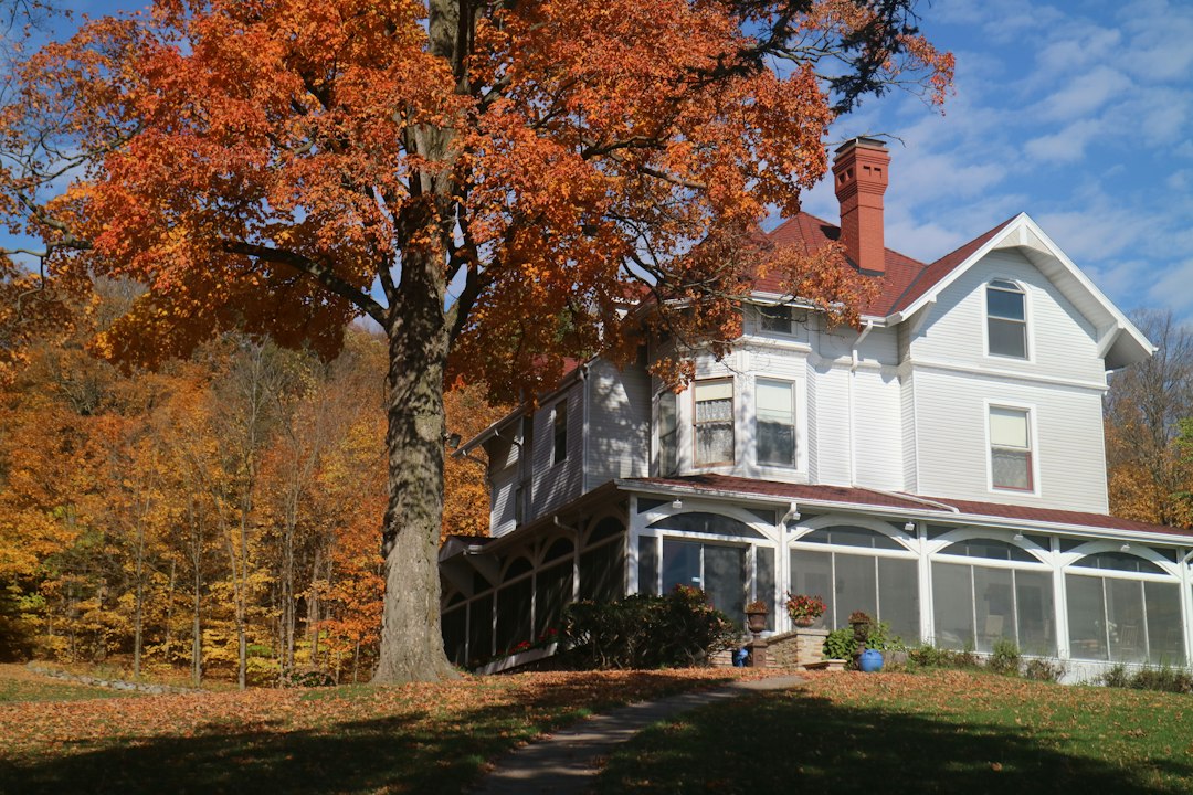Historic New England house surrounded by autumn foliage