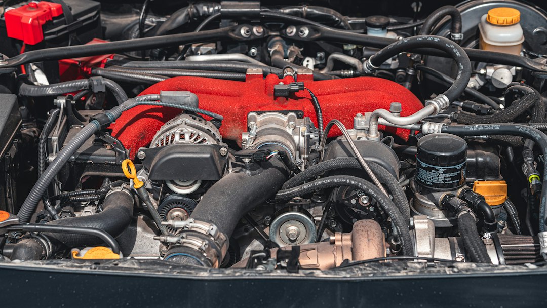 Engine bay close-up showing black coolant hoses and intake