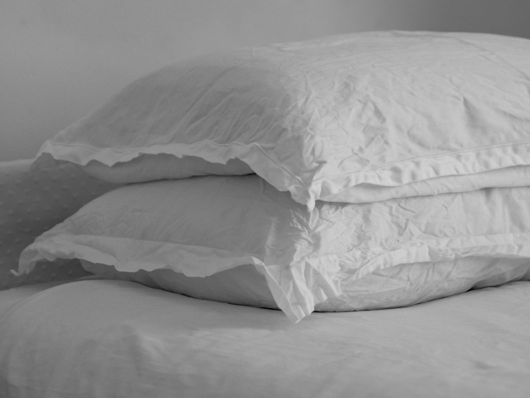 Stack of soft white pillows on a bed