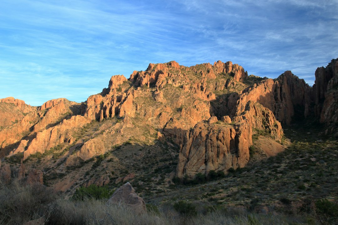 Red-rock peaks of the Chisos Mountains glowing in early morning light inside Big Bend