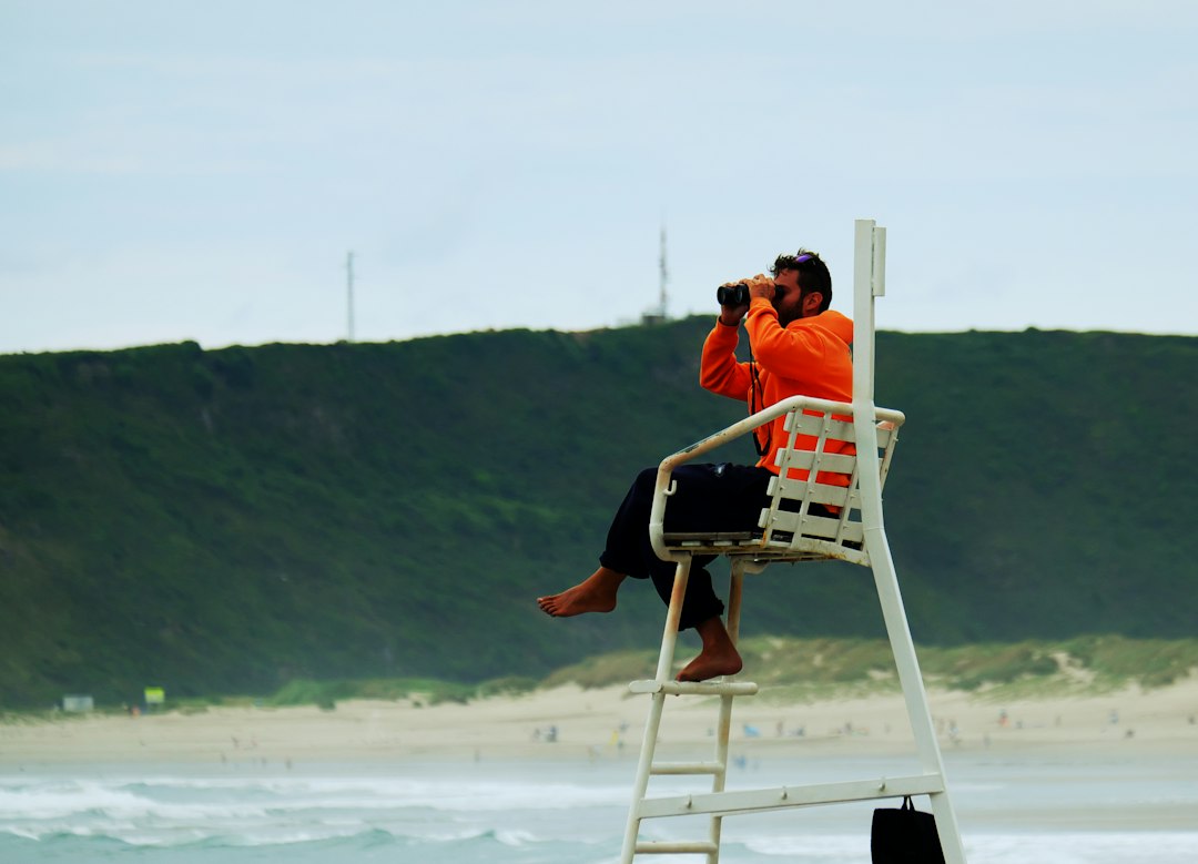 A birdwatcher with a spotting scope at the coast