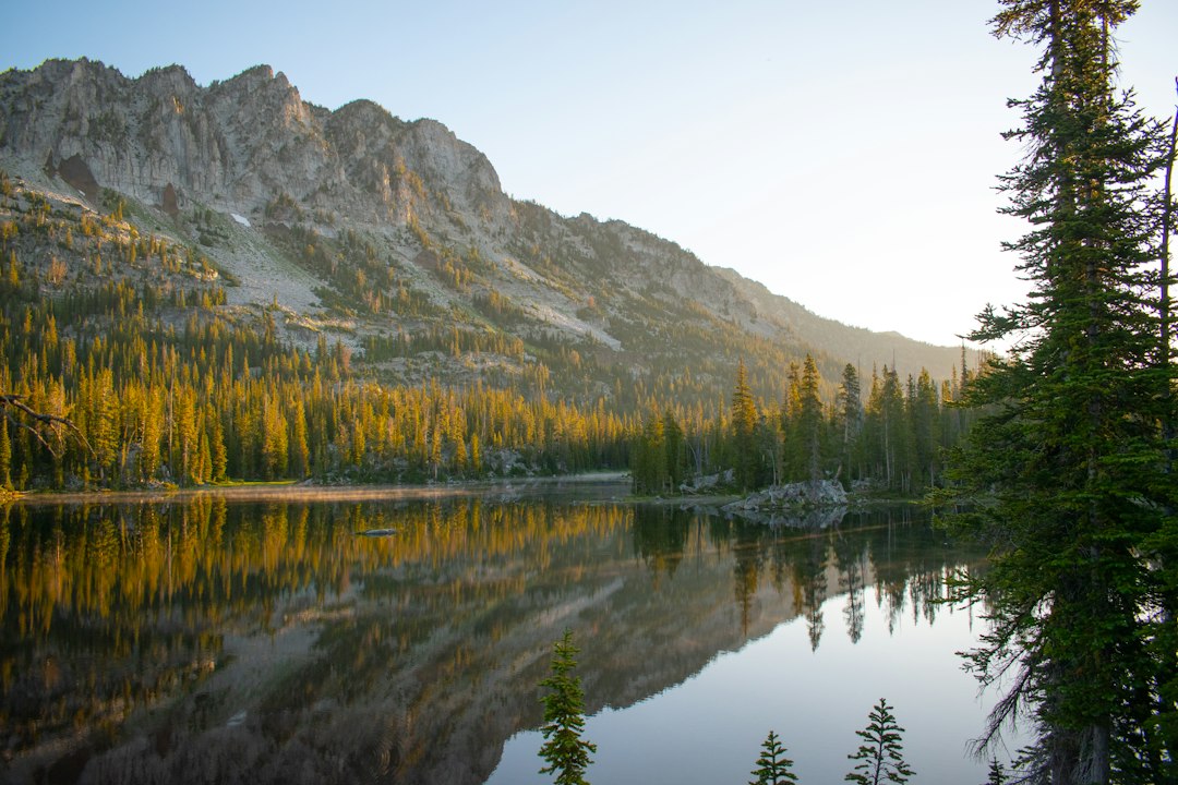 Alpine lake reflecting golden autumn mountains
