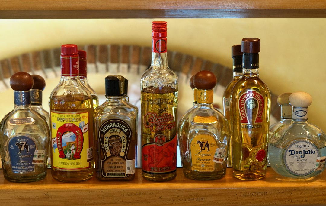 Bottles of agave spirit arranged on a bar shelf in Oaxaca