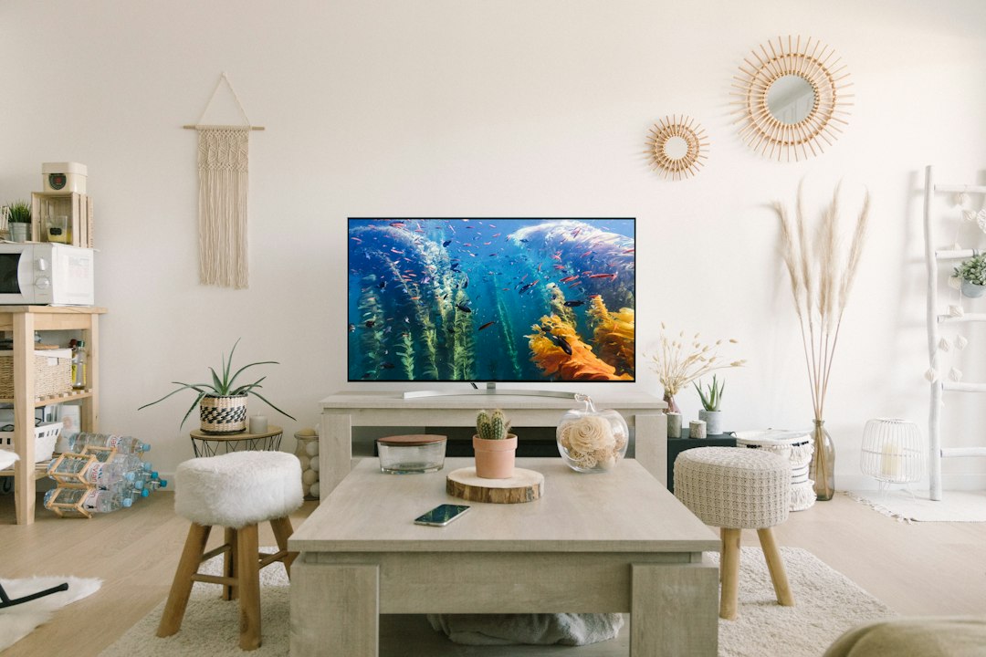 Living room with television on a media console displaying an ocean scene