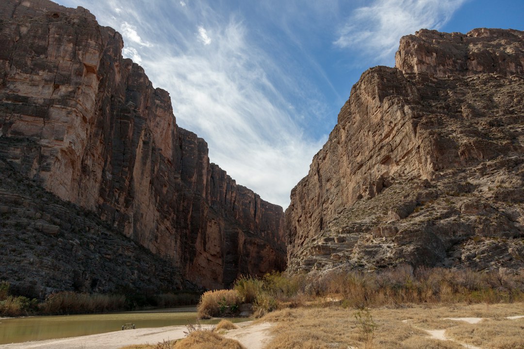 The Rio Grande flowing between the tall rock walls of a deep desert canyon