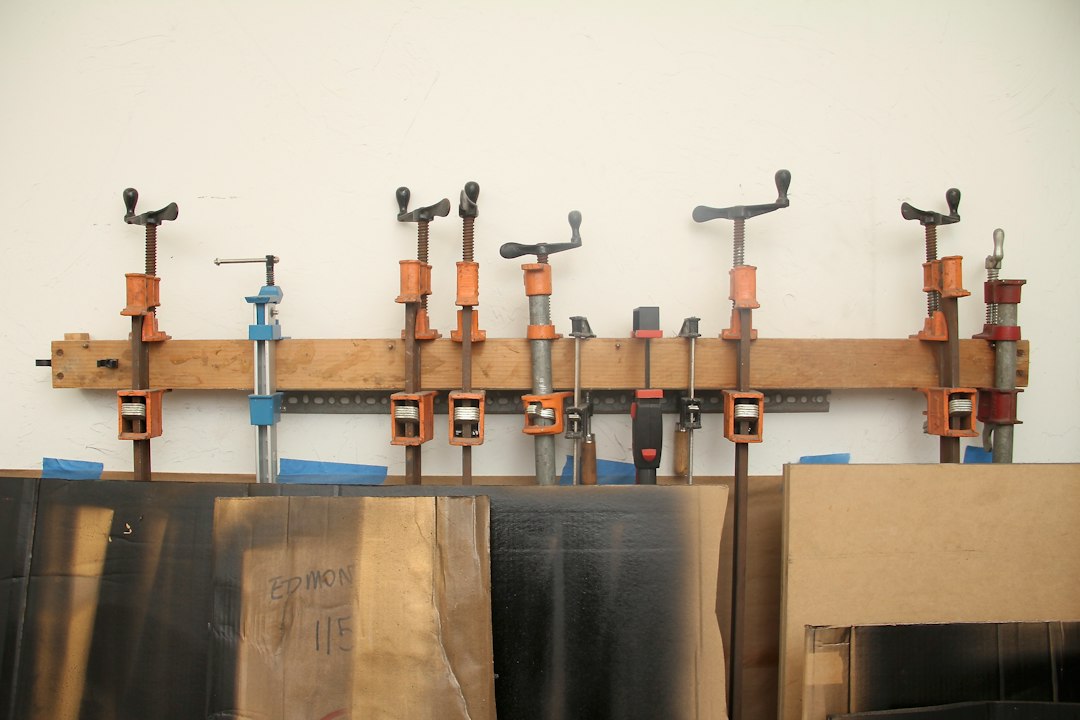 Assorted woodworking clamps mounted on a workshop wall