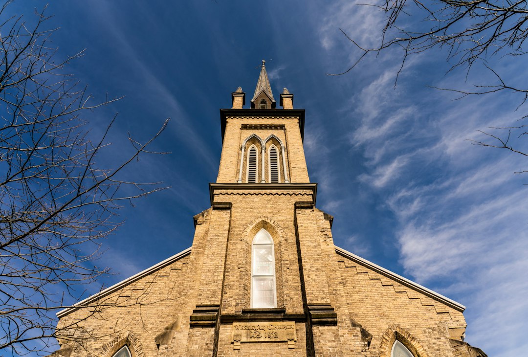 A historic stone church with tall steeple
