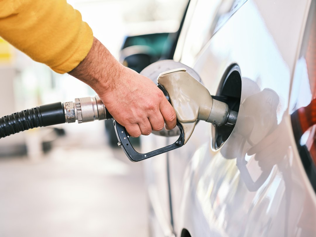 Rental car being refueled at a gas station before return