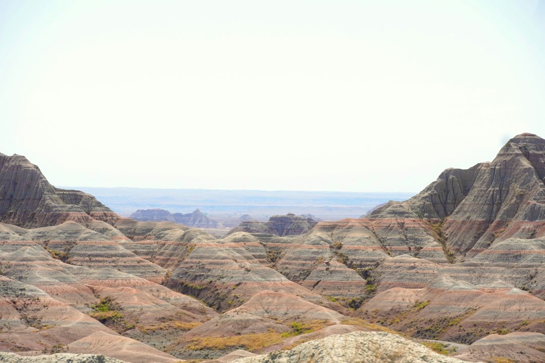 Layered badlands buttes in pink, tan, and gray erosion bands