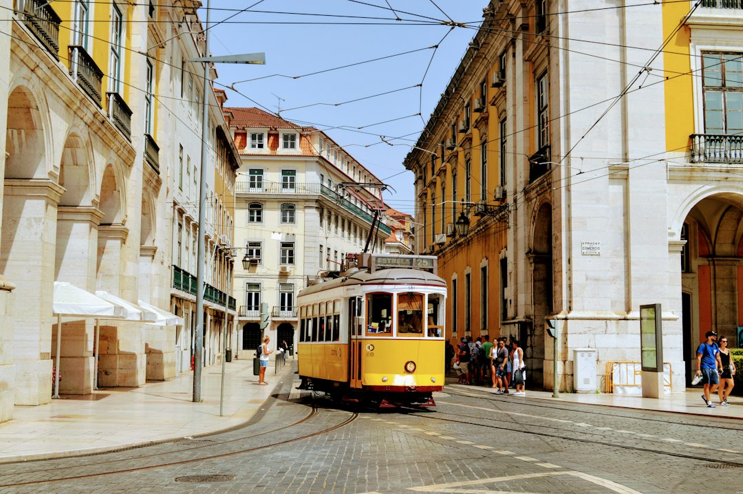 Yellow Tram 28 rounding a curve in Lisbon