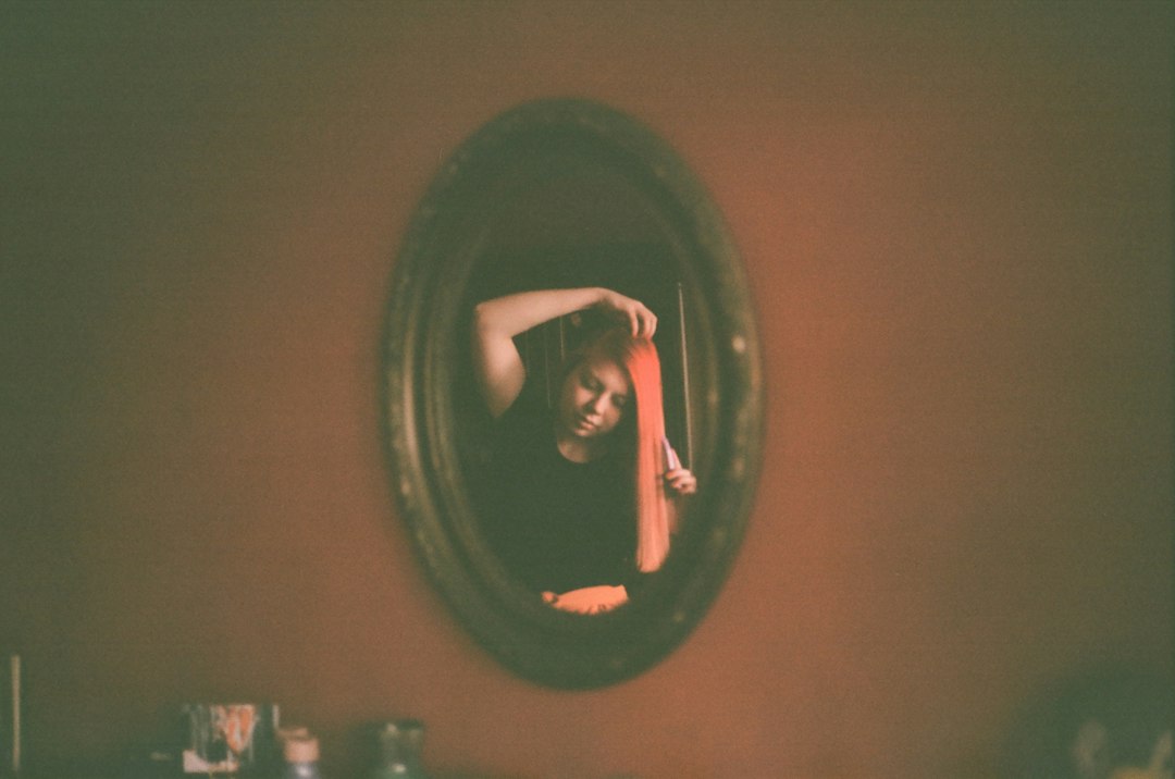 Woman checking her outfit in a mirror while getting ready