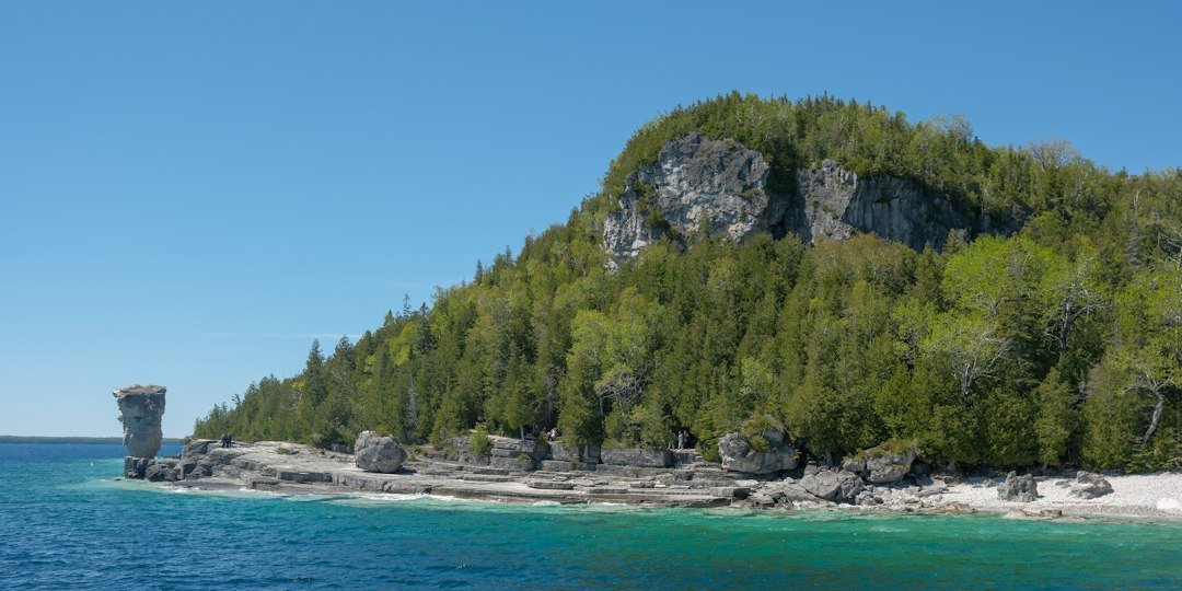 Rocky Great Lakes shoreline with limestone bluff meeting open water