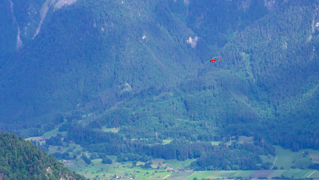 Search and rescue helicopter flying through a mountain valley