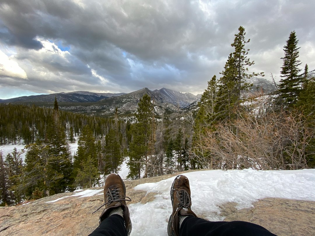 Hiker in boots standing on a snowy trail