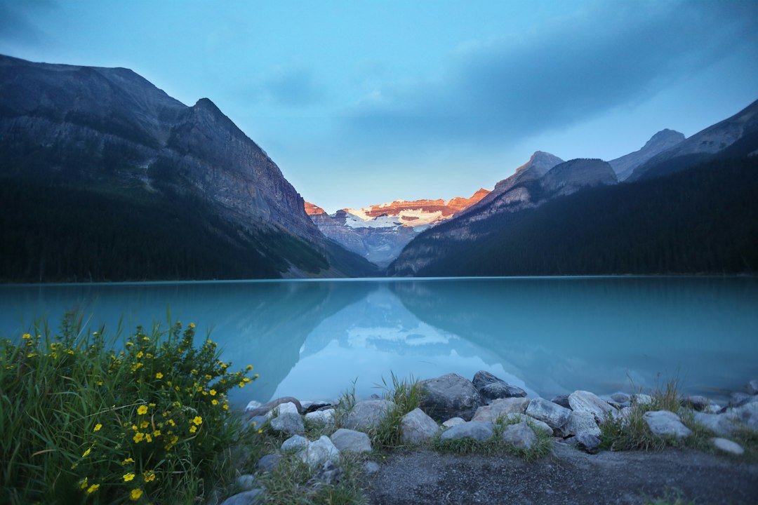 Quiet alpine lake reflecting evening light in the mountains