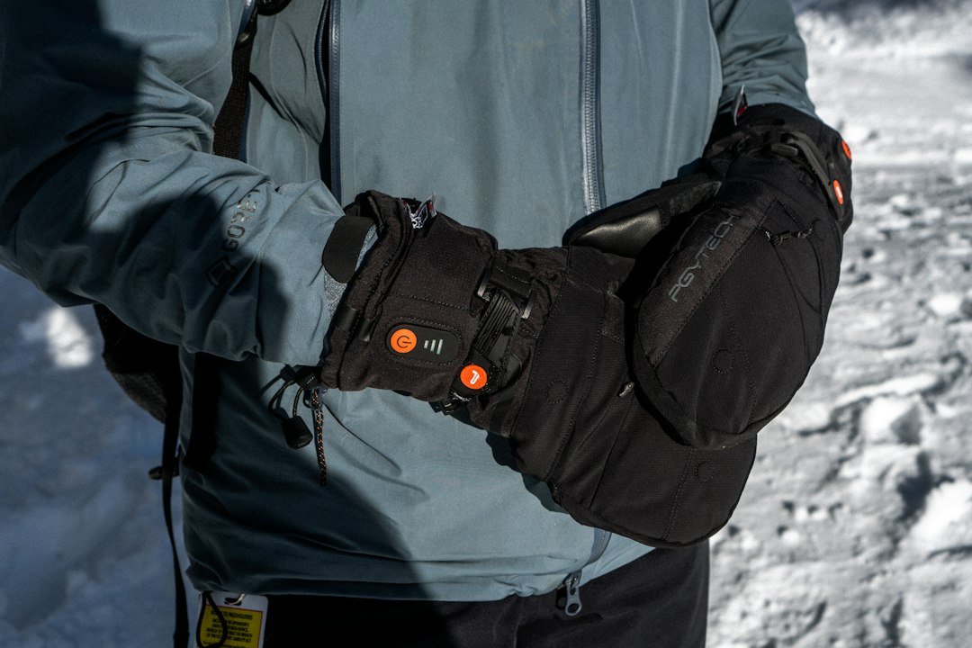 Close-up of heated winter gloves with control buttons