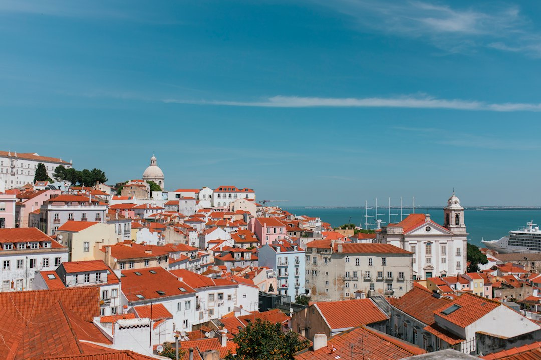 Panoramic view over Lisbon rooftops toward the Tagus River