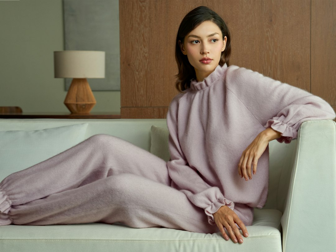 Woman wearing a matching light purple lounge set while relaxing
